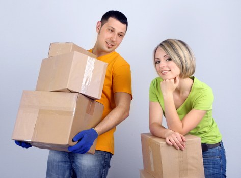 Packed moving boxes and furniture for a home removal service
